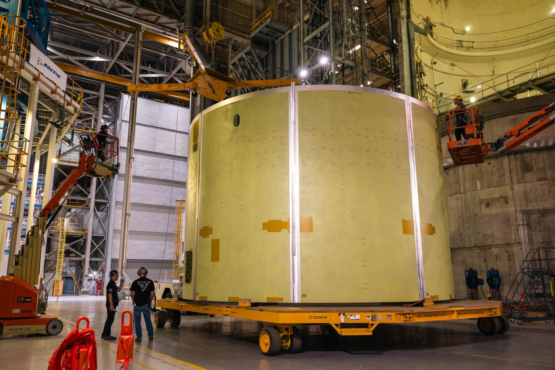 Teams at Michoud Assembly Facility in New Orleans load the engine section barrel into the vertical assembly center on Aug. 5, 2026. The engine section will be used on the SLS (Space Launch System) rocket’s core stage for the agency’s Artemis V mission. On the vertical assembly center tooling, teams will mate the flight hardware to a ring, which will serve as an attachment point for the liquid hydrogen tank later in the production process. The engine section is one of five major elements that make up the 212-foot-tall SLS rocket stage; and houses various avionic systems, the engine thrust structure, and four RS-25 engines. The core stage produces more than two million pounds of thrust to help launch NASA’s Orion spacecraft, astronauts, and supplies beyond Earth’s orbit and to the lunar surface for Artemis.